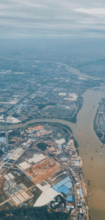 Aerial view of buildings in city against sky