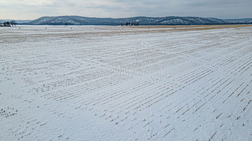 Hills in the background of snow covered fields.