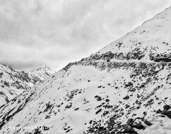 Scenic view of snow covered mountains against sky