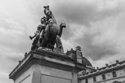 Low angle view of statue against cloudy sky