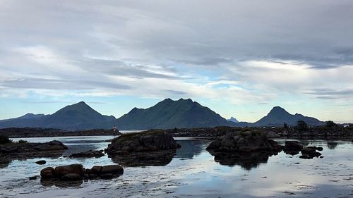 Scenic view of mountains against cloudy sky