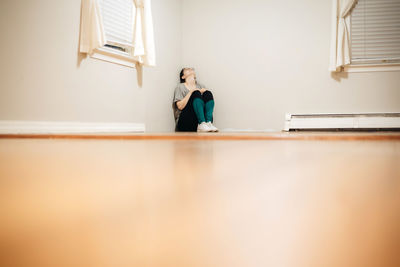 Rear view of woman standing in corridor