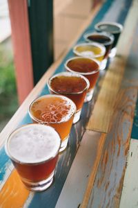 Row of various beer glasses on table