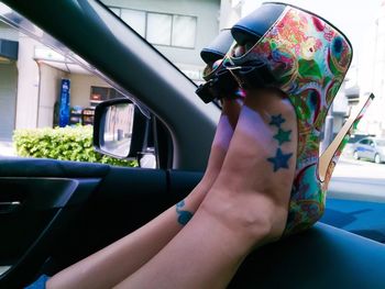Close-up of woman hand in car