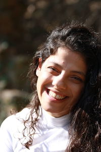 Close-up portrait of a smiling young woman