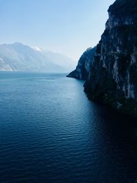 Scenic view of sea and mountains against sky