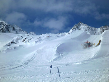 People skiing on snowcapped mountain against sky