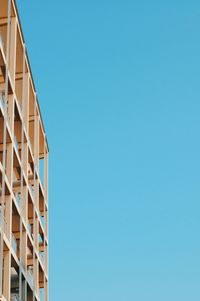 Low angle view of modern building against clear blue sky