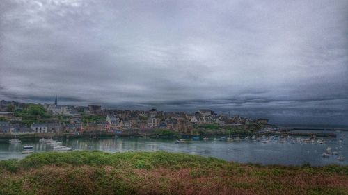 Cityscape against cloudy sky