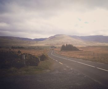 Road amidst landscape against sky