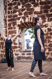 Full length of woman standing by railing