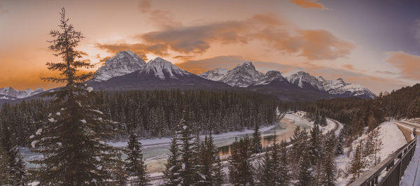 Scenic view of snowcapped mountains against sky during sunset