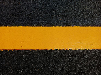 High angle view of yellow road sign on street