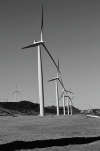 Windmill on field against sky