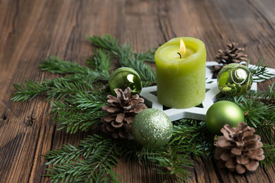 Close-up of lit candle on wreath