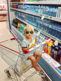 Portrait of young woman standing in supermarket