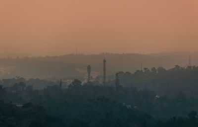 Scenic view of trees against sky during sunset