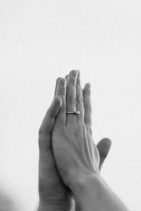 Close-up of hands against white background