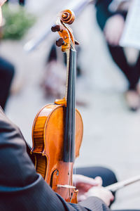 Midsection of man holding violin and bow