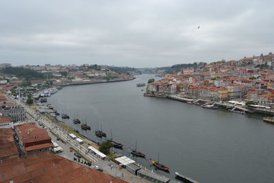 High angle view of townscape by sea against sky