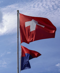 Low angle view of flag against blue sky