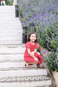 Portrait of a smiling girl sitting on staircase