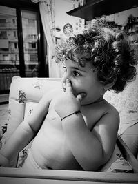 Portrait of young woman sitting on table