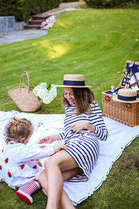 Midsection of women sitting on grass