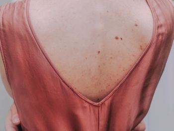 Rear view of woman standing against white background