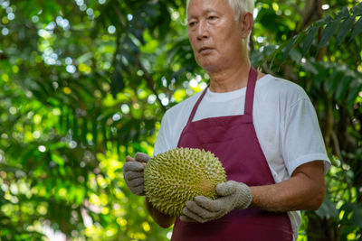 Midsection of man holding plant