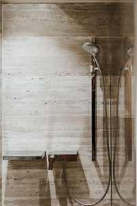 Close-up of wooden table against wall