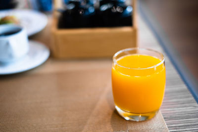 Close-up of orange juice on table