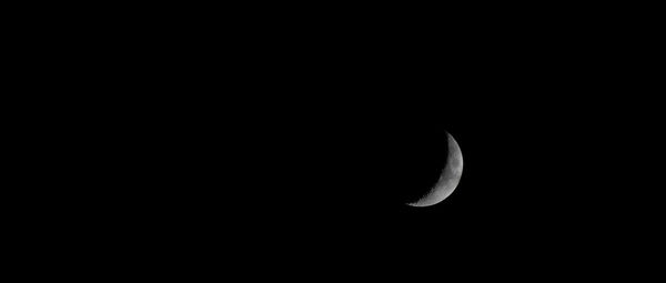 Low angle view of half moon against sky at night