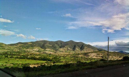 Scenic view of landscape and mountains against sky