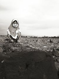 Portrait of a little girl playing on the rocks in the rice field area