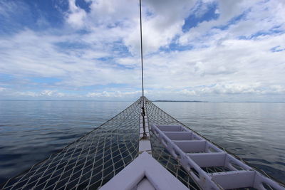 Low section of person on sea against sky