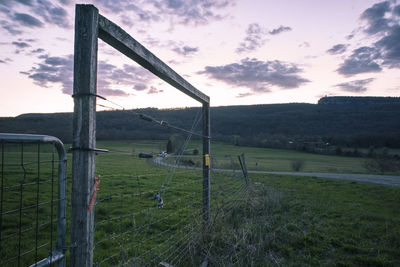 Built structure on field against sky during sunset