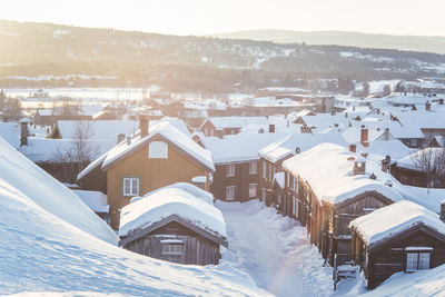 High angle view of snow covered houses in city