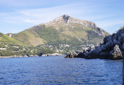 Scenic view of sea and mountains against sky