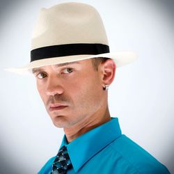 Portrait of man wearing hat against white background
