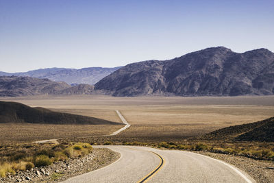 Curved road crossing a desert area in california