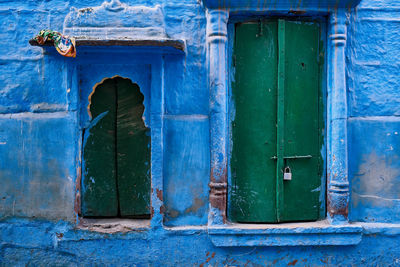 Closed blue door of old building