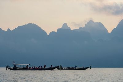 Scenic view of sea and mountains against sky