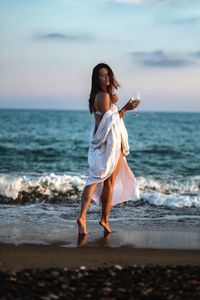Full length of young woman on beach