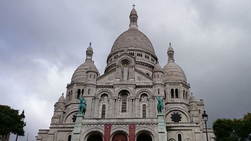 Low angle view of cathedral against cloudy sky