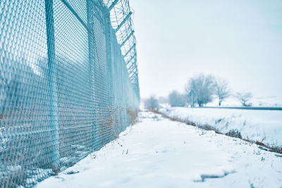 Snow covered field against sky