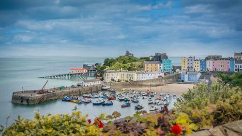 Scenic view of sea and buildings against sky