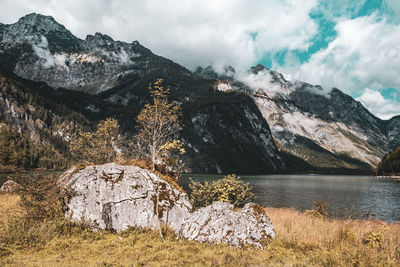 Scenic view of lake by mountains against sky