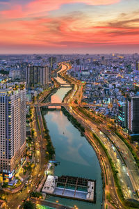 High angle view of illuminated city buildings during sunset