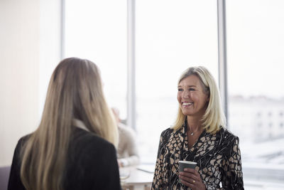 Businesswomen talking during coffee break